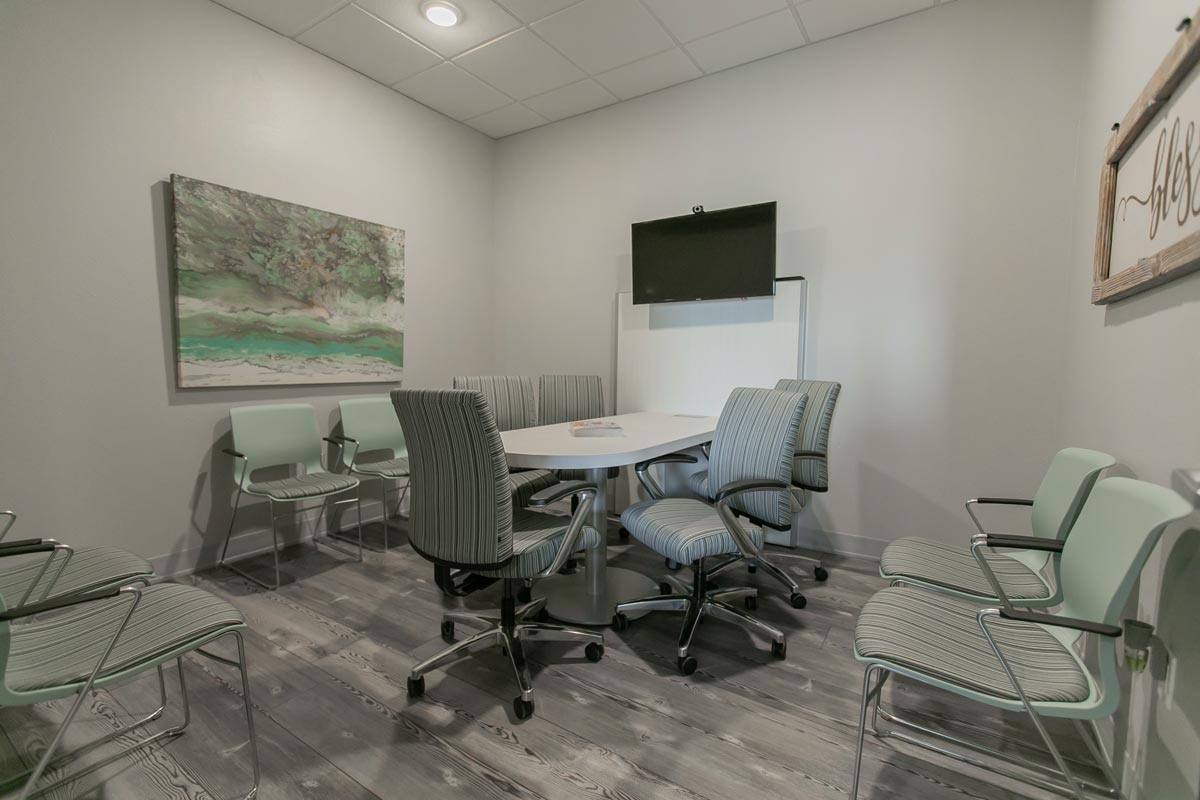 small office meeting room, striped chairs and monitor